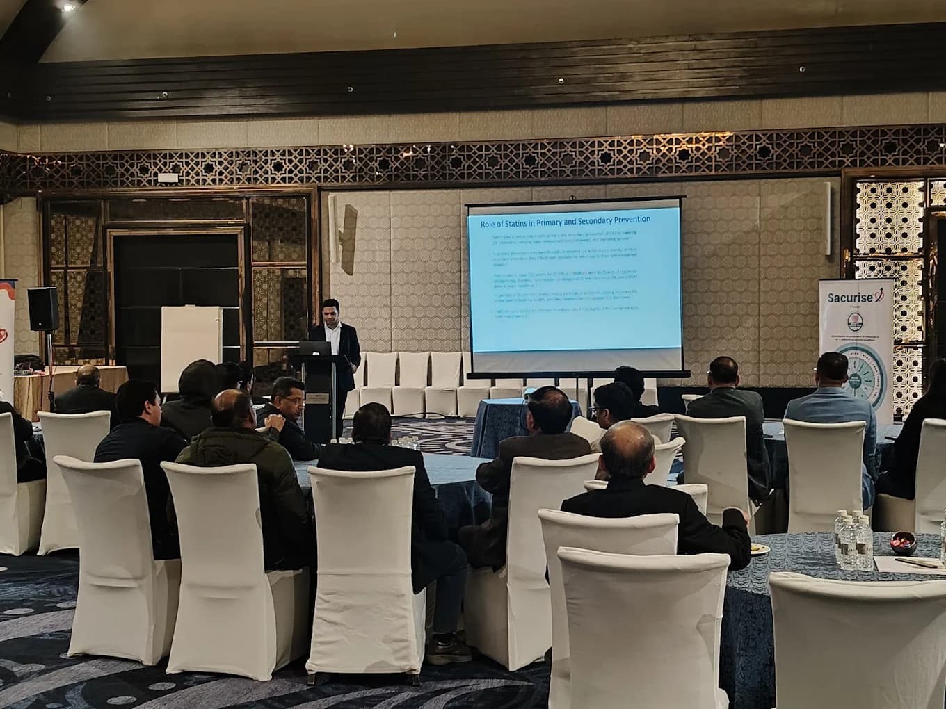 Dr. Pawan Goel presenting on the role of statins at a medical conference
