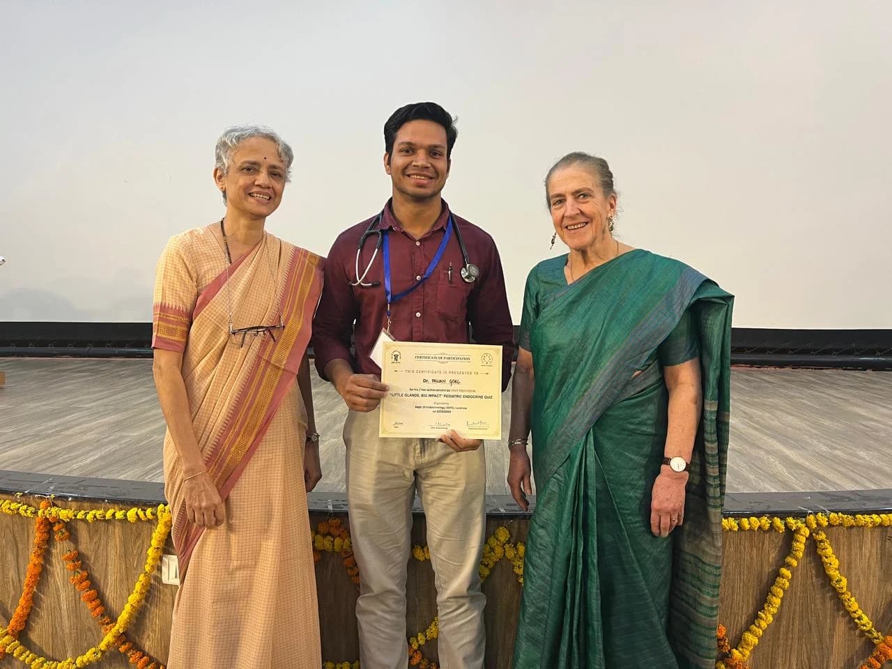Dr. Pawan Goel receiving a quiz award at a pediatric endocrine conference